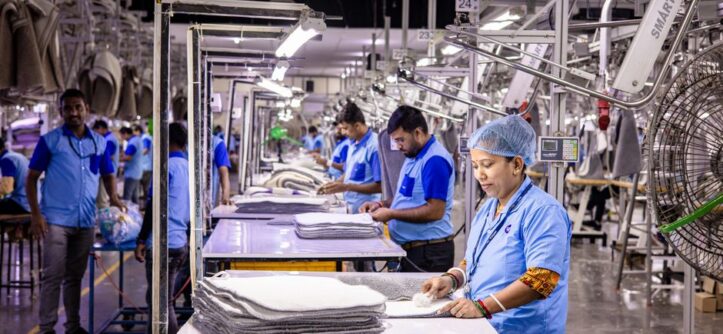 Blue-collar staff in a textile factory focusing on garment production and quality control.